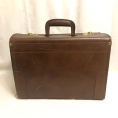 This is a super cool vintage brown leather suitcase. Even if you have no intention on using this as a bag, this would still be an amazing decorative piece to have in the home! There's noticeable wear on all throughout this piece. It's scuffs and scratches are part of its history - imagine all of the places this trunk has traveled to. Approximate Measurements: Height: 12 inches Length: 16 inches Depth: 7 inches Handle drop: 2.25 inches Buy with confidence! All of our packages are insured, so you Brown Briefcase With Luggage Sleeve For Trips, Vintage Brown Luggage For Everyday Use, Rectangular Travel Bag With Leather Lining, Classic Brown Travel Cases, Brown Cases With Luggage Sleeve For Trip, Brown Rectangular Travel Case, Vintage Brown Rectangular Briefcase For Travel, Vintage Leather Travel Bag For Business Trips, Brown Rectangular Travel Briefcase