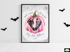 a halloween card with a baby's foot in the center and bats around it