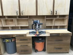 a workbench with tools in it and some cabinets