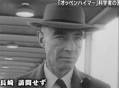 a man in a suit and tie wearing a hat with japanese writing on the side