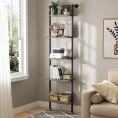 a living room with a couch, chair and shelving unit in front of a window