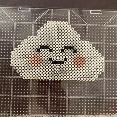 a cross - stitch pattern of a white sheep with black eyes on it's face