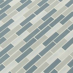 a close up view of a gray and white tile wall