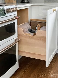 an open drawer in the middle of a kitchen