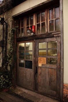 an old building with wooden doors and windows