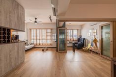 a living room with wooden floors and sliding glass doors