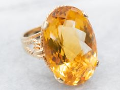 With sleek styling and modern features, this bold cocktail ring is sure to impress. This ring features clean lines and nice proportions, and the yellow gold really accents the stunning golden yellow oval cut citrine dazzling in the center. The rope detail on the band adds uniqueness without taking away from the citrine gemstone.Metal: 14K Yellow Gold Gem: Citrine 25.30 CaratsGem Measurements: 24.6 x 16.2 mm, OvalRing Size: 6.50Marks: “14K” Stamped on the inside band Right Hand Ring, Right Hand Rings, Hand Ring, Citrine Ring, Oval Rings, November Birthstone, Citrine Gemstone, Vintage Love, Golden Yellow