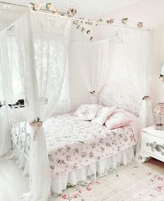 a white bed sitting in a bedroom next to a dresser