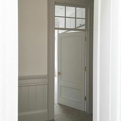 an empty room with white walls and doors