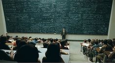 there is a man standing in front of a blackboard with writing that says interesting things