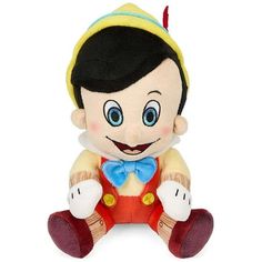 snow white plush toy with blue eyes and black hair sitting in front of a white background