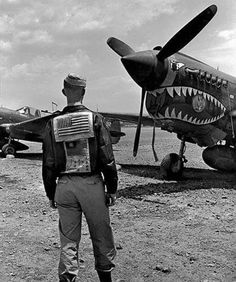 a man standing in front of an airplane