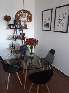 a glass table with chairs and vases on it