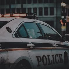 a police car parked in front of a tall building