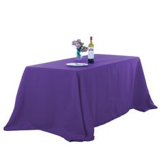 a purple table cloth with two bottles of wine on it