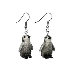 a pair of earrings with a small penguin on it