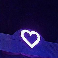 a blue hat with a white heart in the center on it's back side