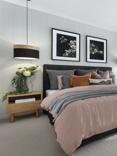 a bedroom with two framed pictures above the bed