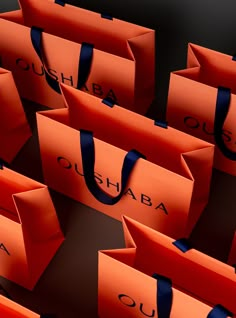 many orange shopping bags with blue handles