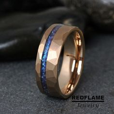 a gold ring with blue stone inlays