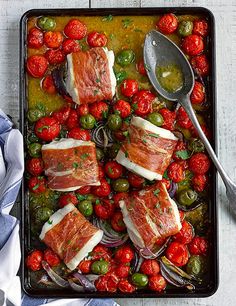 a tray filled with meat and vegetables on top of a table