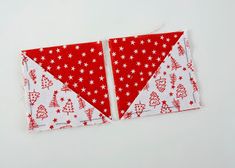 two pieces of red and white fabric are next to each other on a white surface