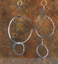 Asymmetric oxidized 925 silver earrings. The earrings made from  silver round profile 0.9 mm / 0.35 inches thick. Earring number one- Two circles : Size: Total length: 6.5cm /2.72 inches. Max Width is: 3.2 cm /0.87inches. Earring number two - three circles : Size: Total length: 7 cm / 2.76 inches. Max Width is: 2.5 cm /0.98 inches. The hook of the earrings is made of silver. Delivery - Eco Post usually comes up to 7-10 business days. If you have any question please do not hesitate to contact me. Thank you, Adi Contemporary Handmade Jewelry, Round Profile, Hammered Jewelry, Artisan Jewelry Handmade, Rustic Earrings, Hammered Earrings, Art Earrings, Le Crochet, Rustic Jewelry