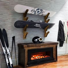 a fireplace with skis and snowboards on it