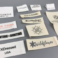 several different types of labels are shown on a gray surface with white and black lettering