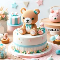 a teddy bear sitting on top of a cake surrounded by cupcakes and candies