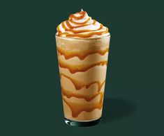 a tall glass filled with ice cream and caramel swirls on a green background