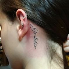 a woman's behind the ear has a tattoo on her left side that reads, whatever