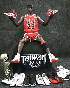 a basketball player sitting on top of a ball with his hands up in the air