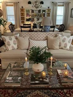 a living room filled with lots of furniture and decor on top of a coffee table