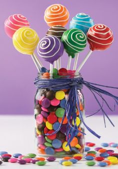 a jar filled with lots of colorful lollipops