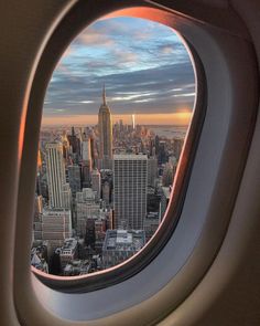 an airplane window looking out at the city