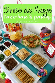 a table filled with tacos, chips and sauces for a cinco de mayo party