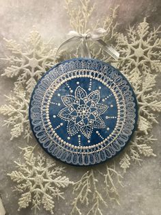 a blue and white plate sitting on top of snow flakes