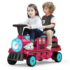 two children are riding on a toy train