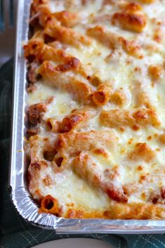 a cheesy casserole dish with meat and cheese on top is ready to be eaten