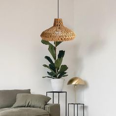 a living room with a couch, table and lamp on it's side wall