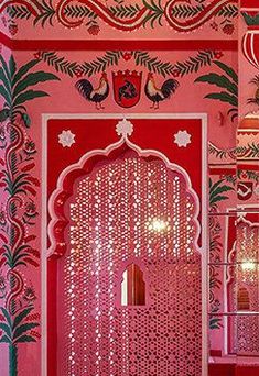 an intricately decorated room with pink walls