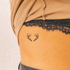 the back of a woman's stomach with deer antlers on it