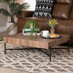 a coffee table sitting on top of a rug next to a couch