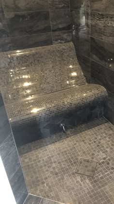 a tiled shower with a bench in it