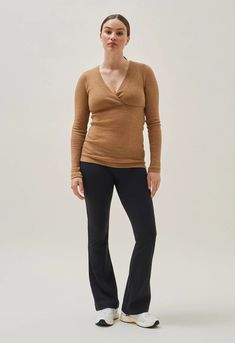 This ribbed wool sweater is designed to fit well before, during, and after pregnancy. Great for everyday use or as a cozy underlayer for winter activities. Made of soft, breathable wool that keeps you warm and wicks away moisture. The wool rib knit adapts to fit growing pregnant bellies and the flattering wrap cut enables easy nursing access. Machine wash: wool program in a laundry bag. Shape while wet, and lay flat to dry. Do not tumble dry. Tip! Wool has self-cleaning properties. Air your wool Pregnant Bellies, Post Partum Outfits, Maternity Brands, Nursing Top, Baby Wrap Carrier, Nursing Tops, Sleep And Loungewear, Nursing Clothes, Pregnant Belly