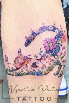 a woman's thigh with flowers and butterflies on it