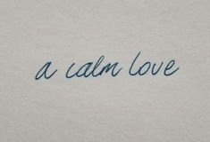 the word'a calm love'written in cursive ink on a piece of paper