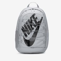 the nike backpack is white with black and grey print on the front, it's zipper