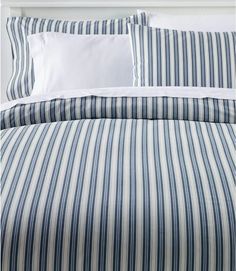 a bed with blue and white striped sheets